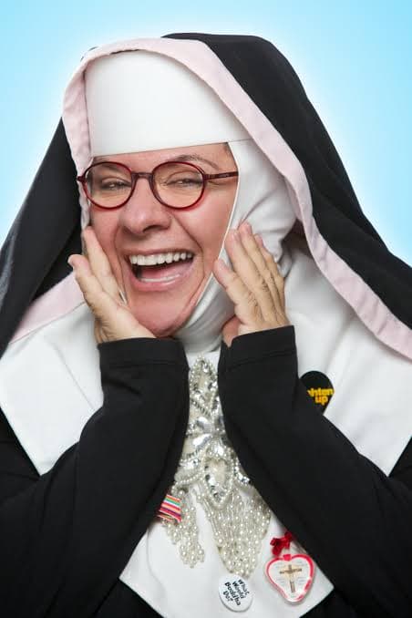 The Reverend Mother, laughing in her nun's habit